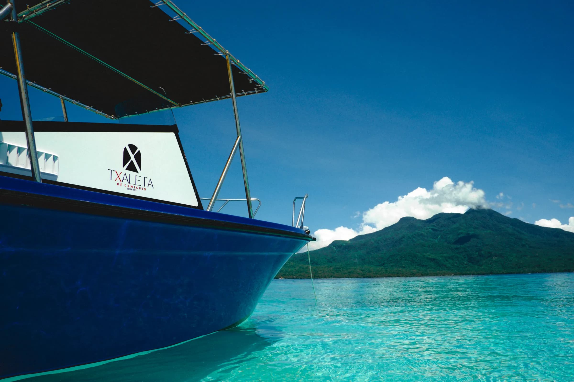 The Txaleta boat over the turquoise shallows of White Island