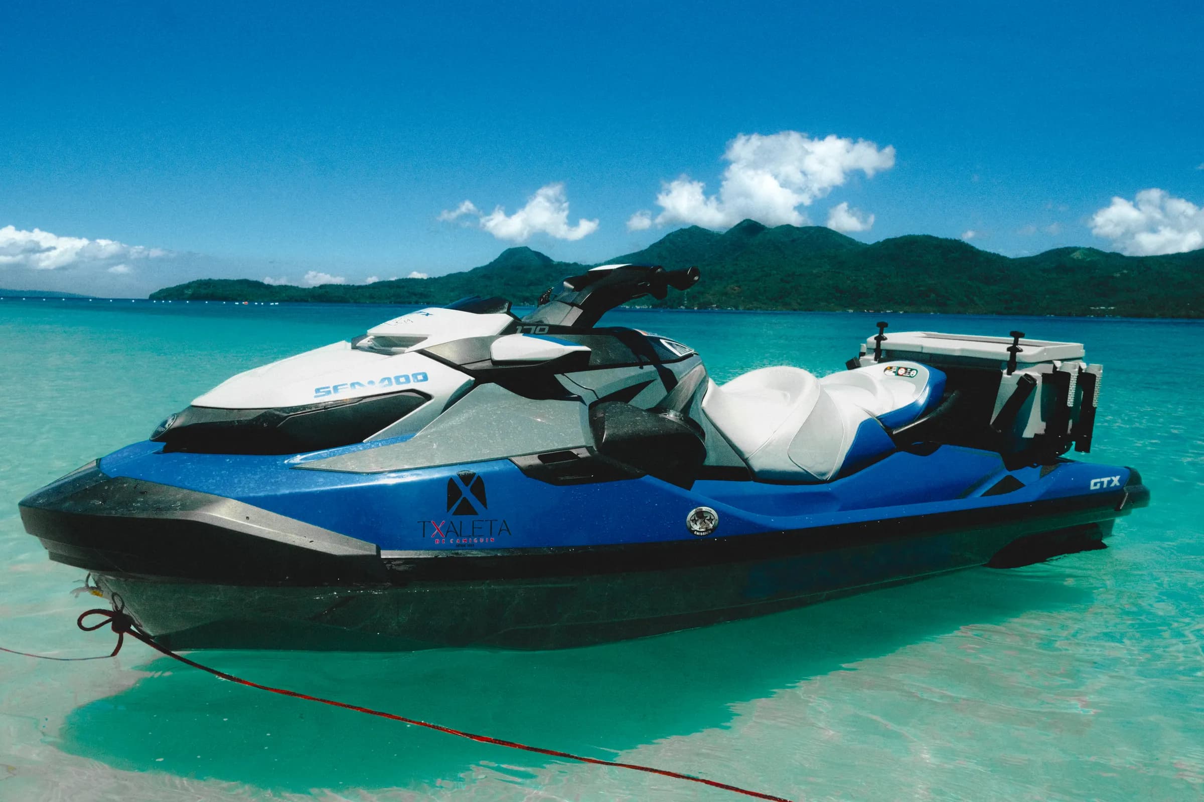 A Txaleta jet ski resting in the shallows off Camiguin