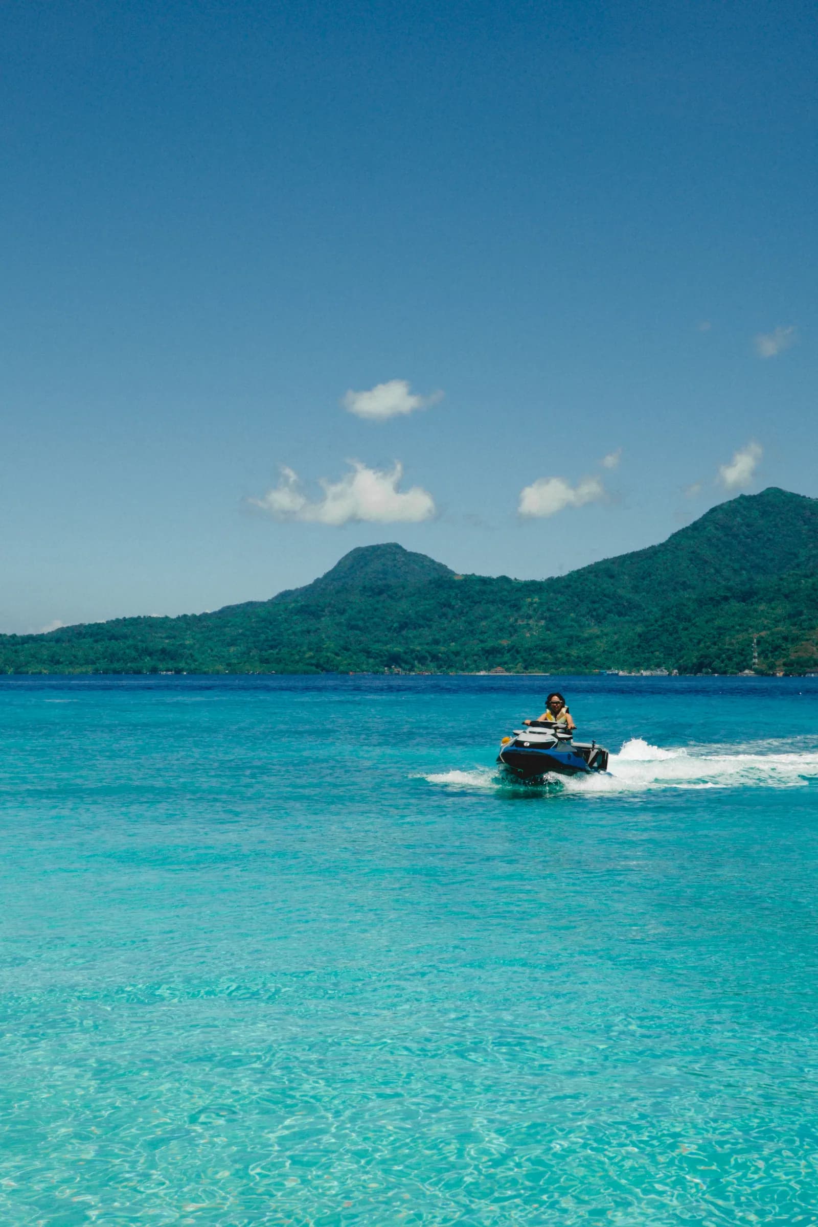 Riding a jet ski over the clear waters of White Island